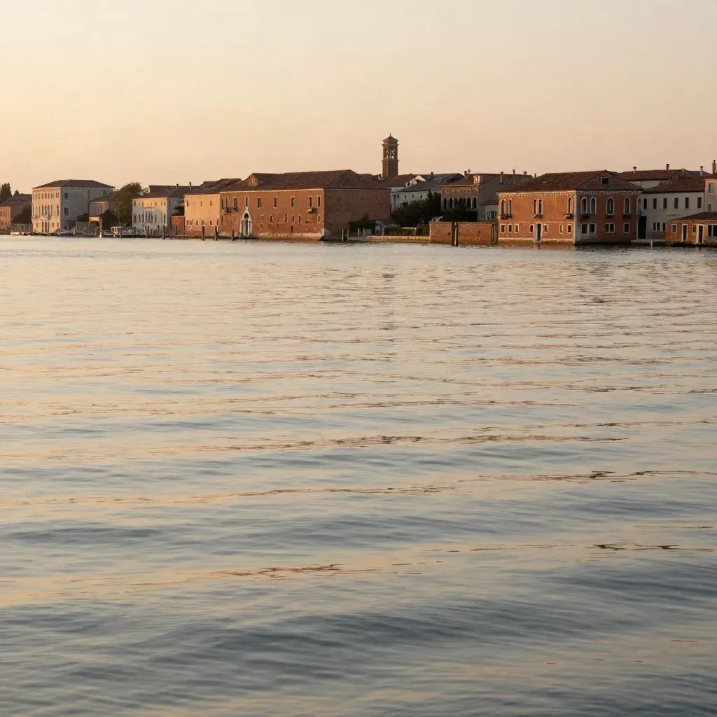 Laguna veneziana al tramonto, skyline basso e acqua calma con luce dorata.
